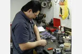 A man working on some parts in a shop