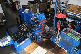 A garage with many tools and equipment on the floor.