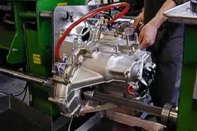 A person working on an engine in a shop.