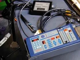 A blue and white control panel with wires